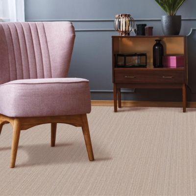 beige carpets in a living room with pink chair